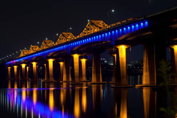 istock low-angle view of the illuminated bridge on Han River in the night 2206043075