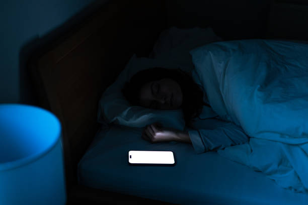 istock Girl using a smart phone on the bed in the night 2206044491