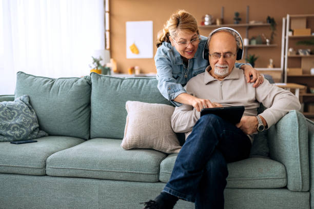 istock Senior couple using digital tablet at home together 2206044742