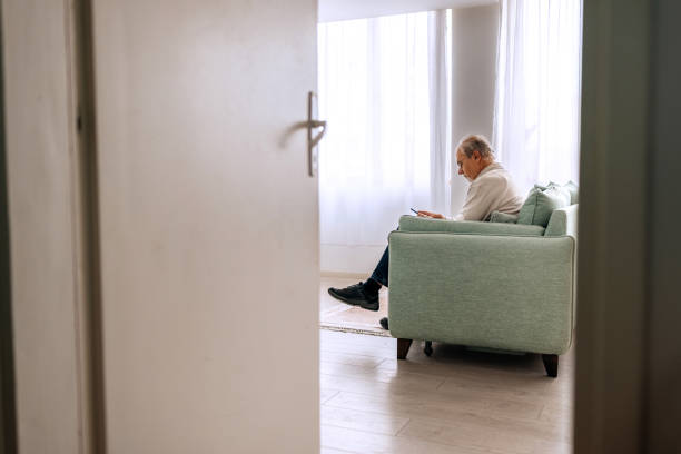 istock Senior man relaxing at home and using mobile phone 2206045153
