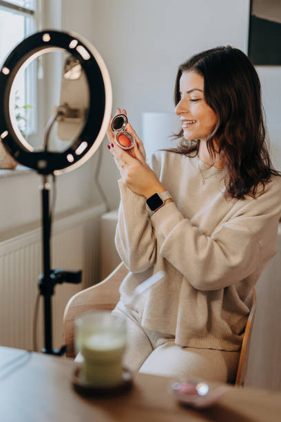 istock Woman applying make-up and recording vlog 2206045385