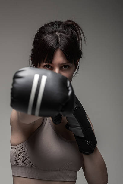 istock Focused young woman practices boxing, determination in her gaze 2206045466