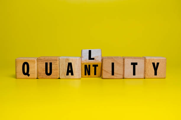 istock flip wooden blocks with quality and quantity words isolated on yellow background 2206046158