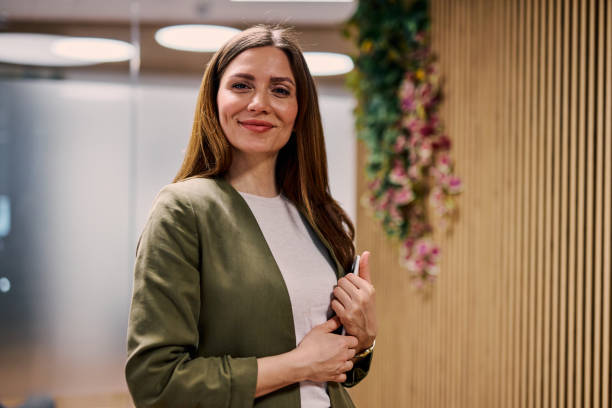 Confident businesswoman smiling in modern office environment
