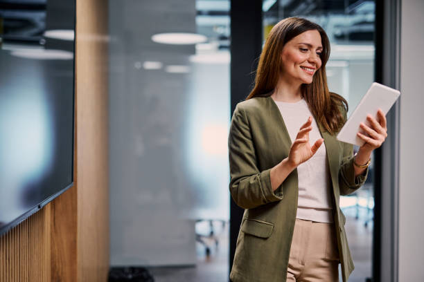 istock Smiling businesswoman using digital tablet in modern office 2206047183