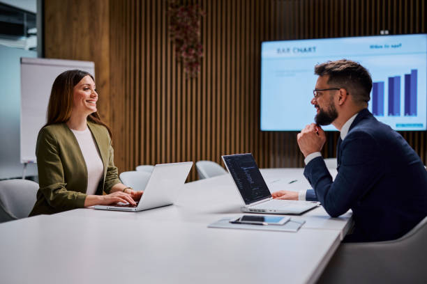 istock Business People Working on Laptops in a Meeting Room 2206047358