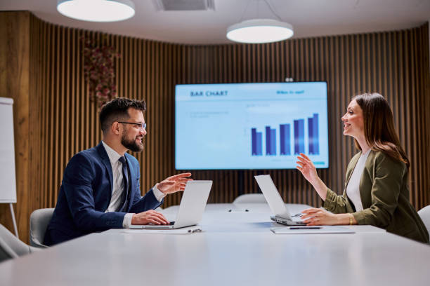 istock Businesspeople discussing bar chart during meeting in conference room 2206047608