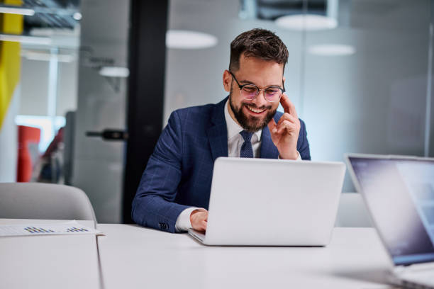 istock Businessman working on laptop and having a call in modern office 2206047641