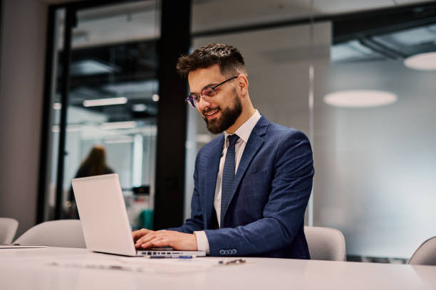 istock Young businessman working on laptop in modern office 2206047680