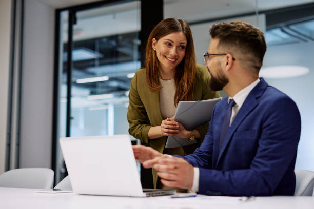 istock Business colleagues discussing work on laptop in modern office 2206048077