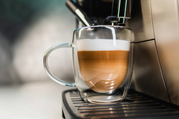istock Home professional coffee machine makes cappuccino in transparent cup 2206048482