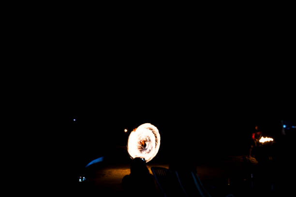 Beautiful flame out of fire-eater's mouth. On black background.