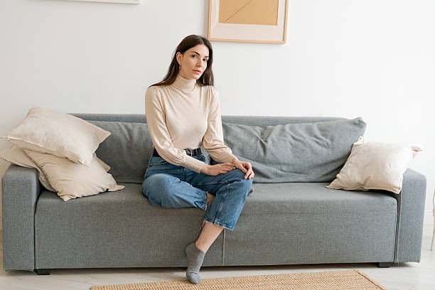 Woman is sitting on a couch