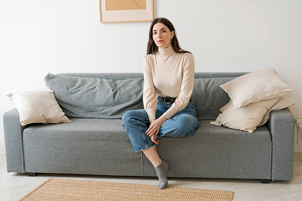 istock Woman is sitting on a couch 2206054340