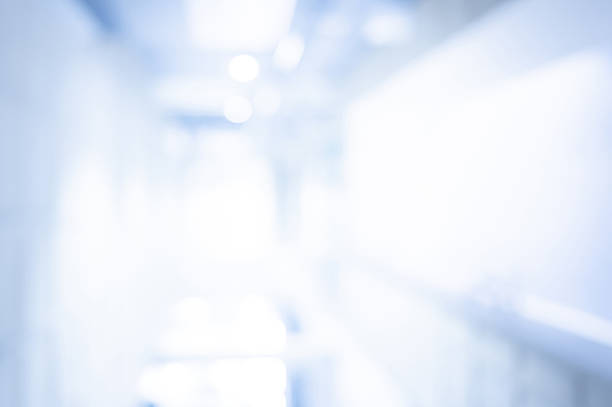 istock Abstract blurred hospital corridor background. Blurry hallway perspective in a medical clinic. Empty interior space with defocused effect for background, backdrop or advertising in health concept 2206054607