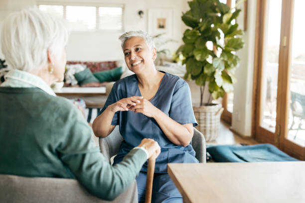istock Smiling Through Support: Elderly Woman and Nurse 2206056223