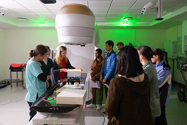 istock Medical physicist students studying advanced oncology equipment linear accelerator in a hospital training session with teacher 2206056474