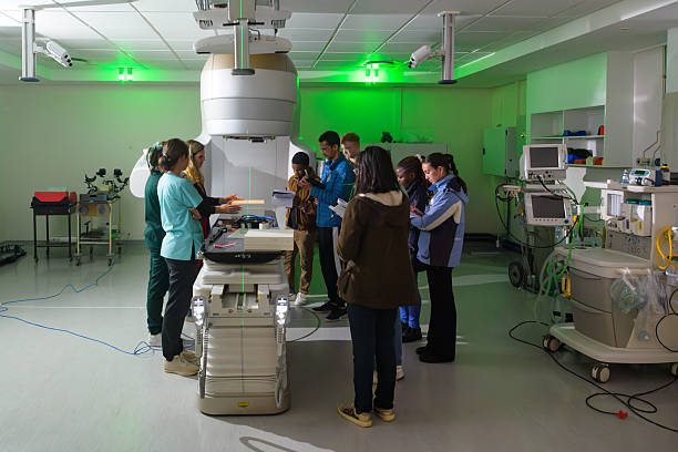 istock Medical physicist students studying advanced oncology equipment linear accelerator in a hospital 2206056477