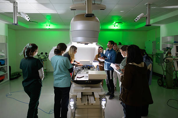 istock Medical physicist students studying advanced oncology equipment linear accelerator in a hospital training session 2206056479