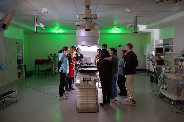 istock Wide shot Medical physicist students studying advanced oncology equipment linear accelerator in a hospital training session 2206056515