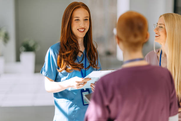 istock Young female nurses chatting in a hospital corridor 2206056635