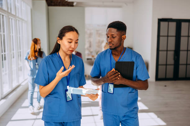 istock Two healthcare professionals discussing work at hospital 2206057683