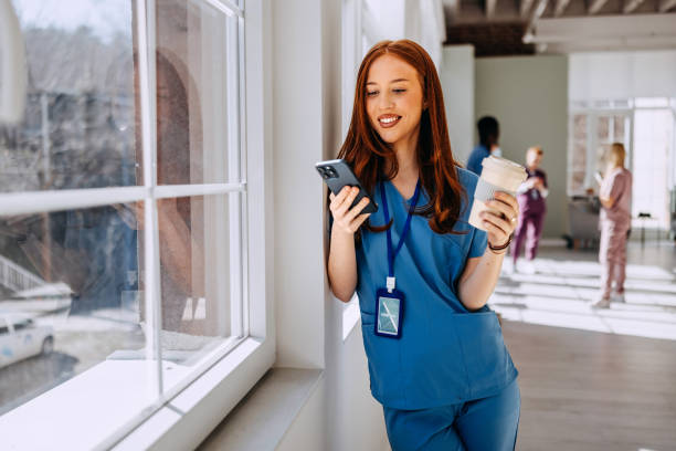 istock Smiling female nurse using a smartphone during her break at the hospital 2206057722
