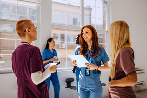istock Young female nurses chatting in a hospital corridor 2206057929