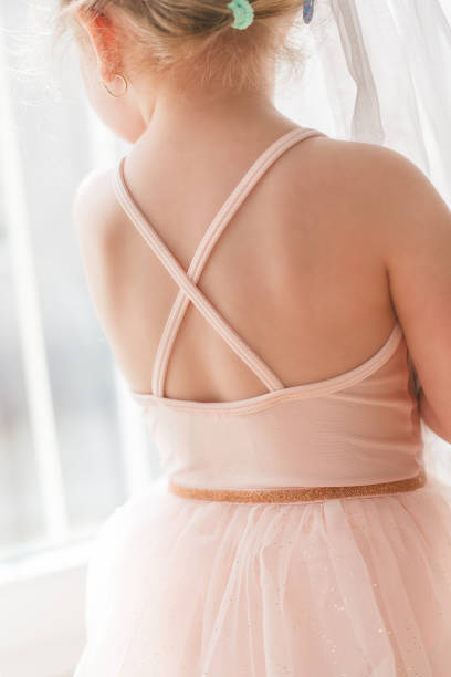 Online classes. The little girl is engaged in ballet. Dancing. Home.