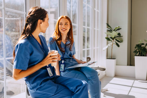 istock Female colleagues talking at hospital corridor 2206057989