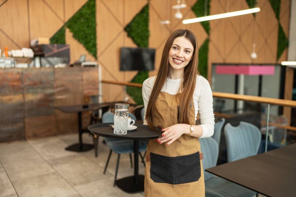 istock Portrait of a beautiful waitress working at a cafe serving coffee 2206058747