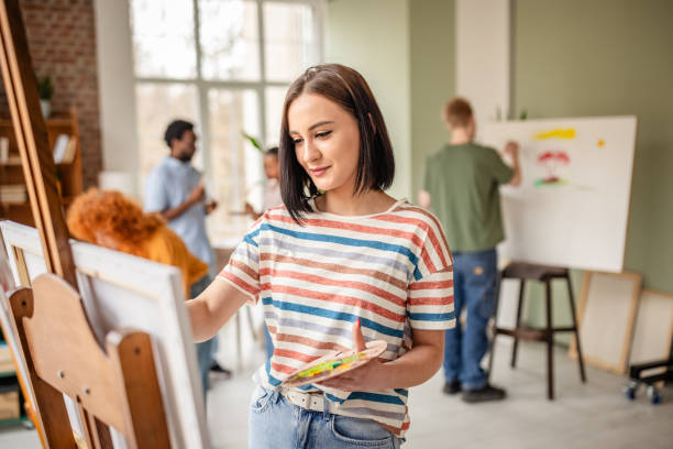 istock Group of young artists creating their masterpieces in a vibrant art studio environment 2206060595