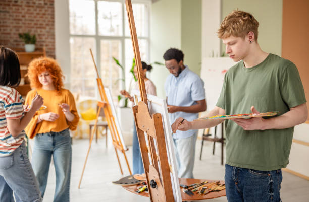 istock Group of young artists engaged in creative activities at an art studio during a vibrant workshop 2206060710