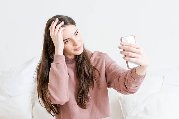 istock Woman is taking a selfie with her cell phone 2206062714