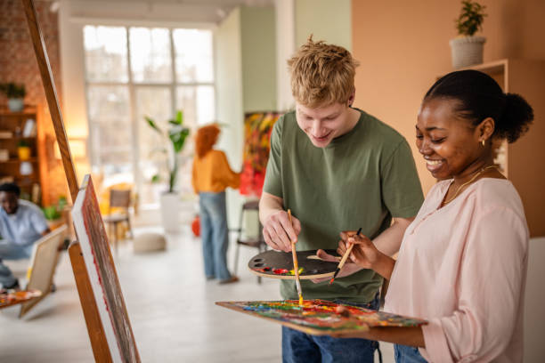 istock Young artists collaborate and create colorful artwork in a vibrant art studio filled with inspiration and creativity 2206062980