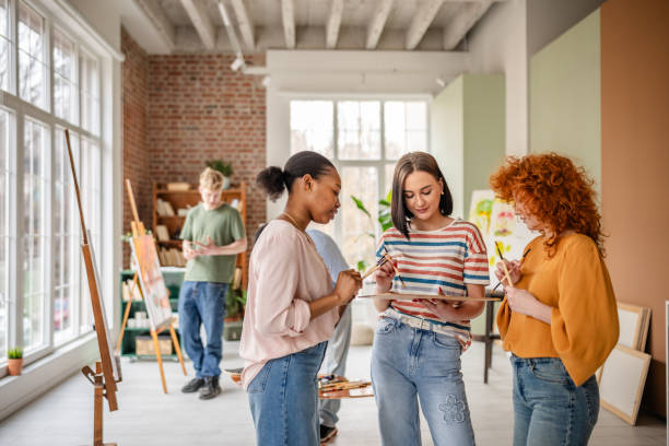 istock Young artists collaborate and create in a brightly lit art studio, sharing ideas and inspiration during their creative workshop 2206063047