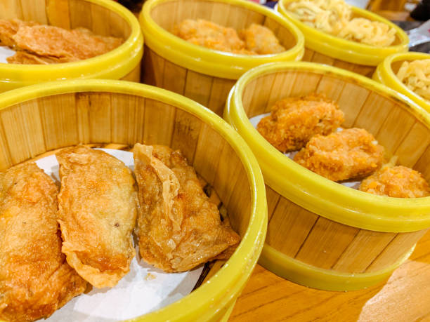 istock Fried Dumplings in a bamboo steamer bowl. Chinese food menu. 2206063662