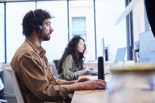 istock Colleagues are working together in a creative office at a shared desk. 2206063672