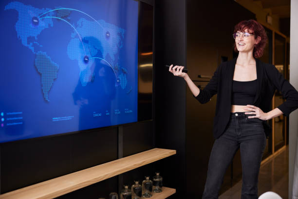 istock A woman is presenting during a business meeting, with a screen displaying her presentation. 2206065913