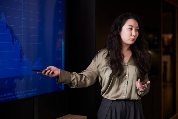 istock A woman presents data on a screen during a business meeting. 2206065921