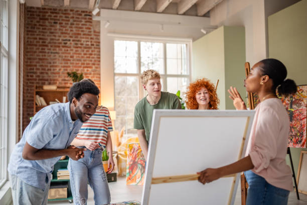 istock Young artists collaborate in a vibrant studio, sharing ideas and inspiration while creating unique artwork together 2206066212