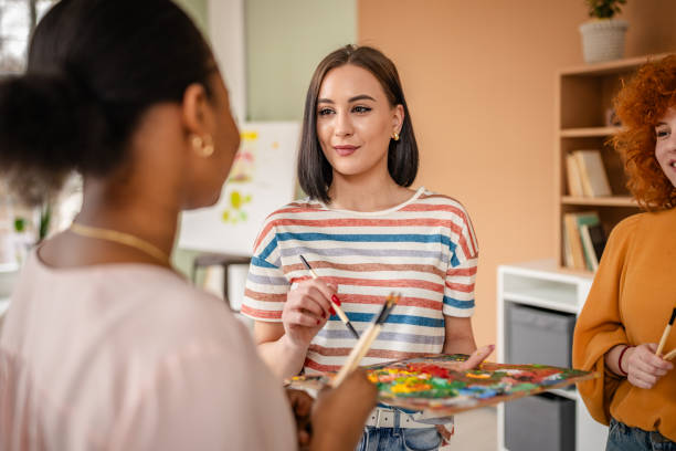 istock Young artists collaborate in an art studio, sharing ideas and inspiration during a creative workshop 2206066374