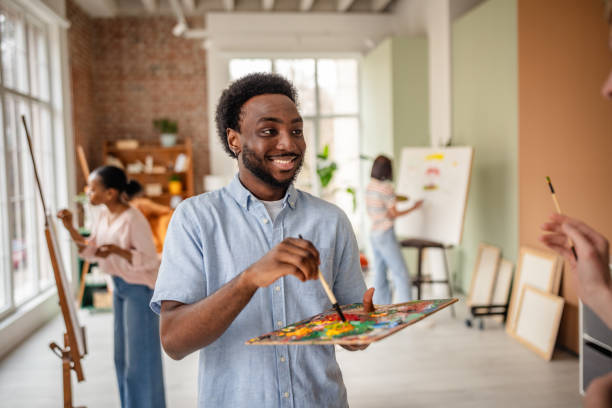 istock Young artists collaborate in an inspiring art studio, sharing creativity and techniques during a vibrant workshop 2206066579