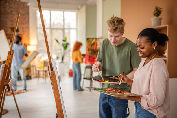 istock Young artists collaborate in vibrant art studio, expressing creativity and joy through painting and craft activities 2206066859