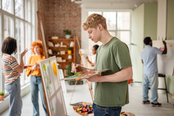istock Young artists engage in creative expressions at an art studio during a collaborative workshop, showcasing diverse skills and inspiration 2206069891