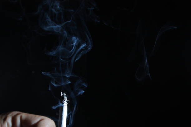 istock cigarette and smoke isolated black background 2206069976