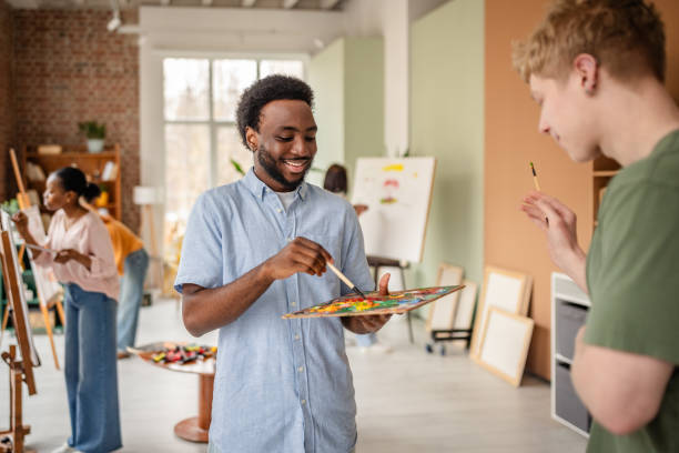 istock Young artists engage in creativity at a lively art studio with a focus on collaboration and skill development 2206070202