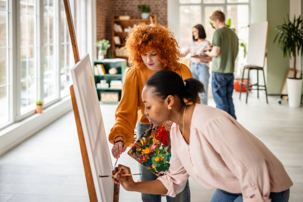 istock Young artists explore creativity in a vibrant art studio through painting and collaboration 2206072040