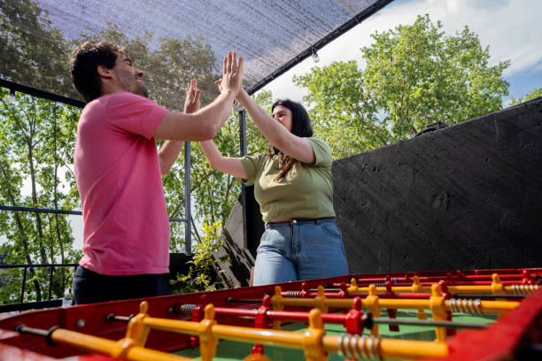 istock Couple celebrating during foosball match in a hostel 2206072344
