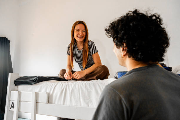 istock Roommates talking in a hotel room 2206072476